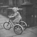 Ann b-1949 on her tricycle